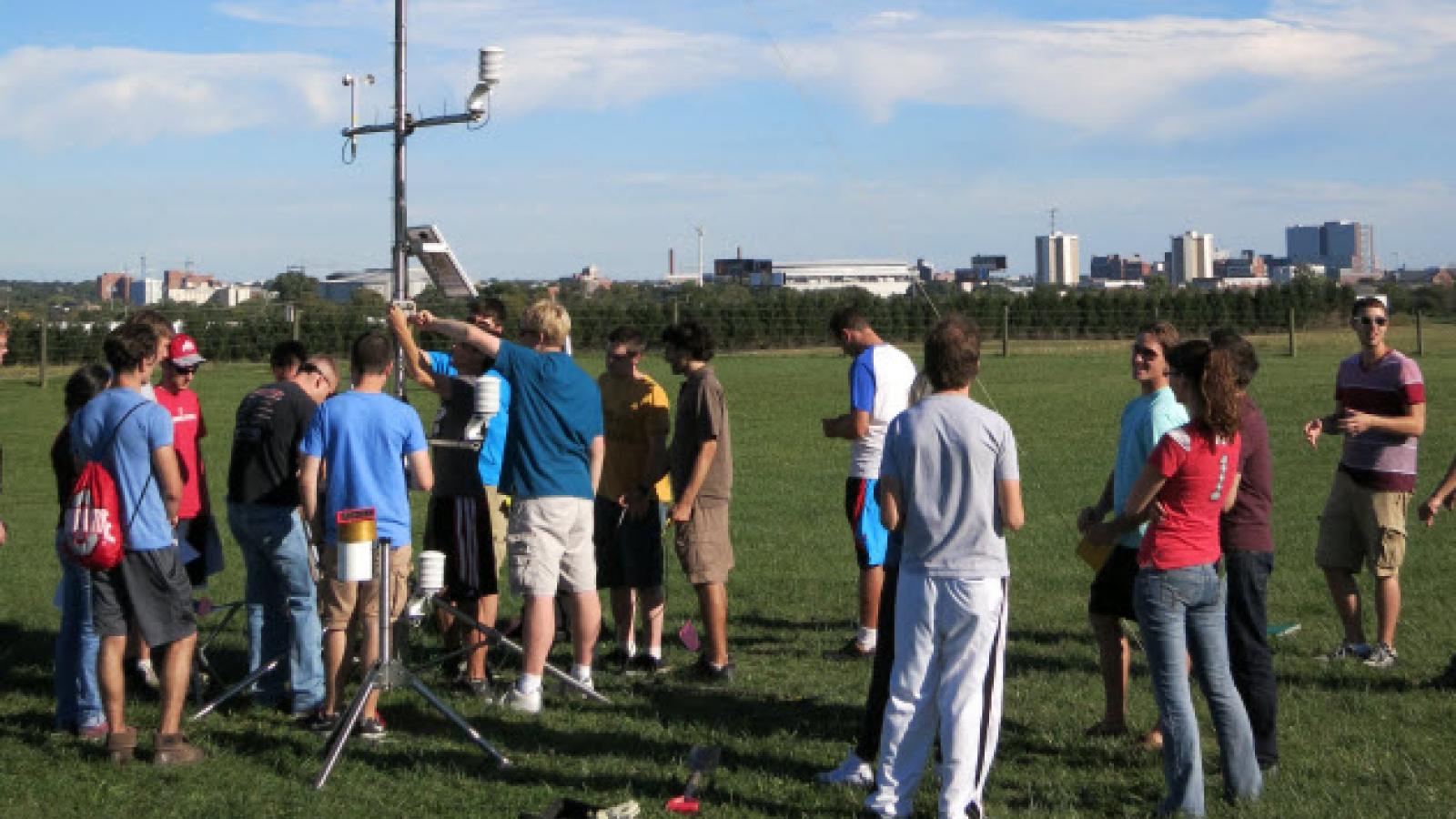 Students, of Microclimatology 5922, in action setting up a weather instruments tower