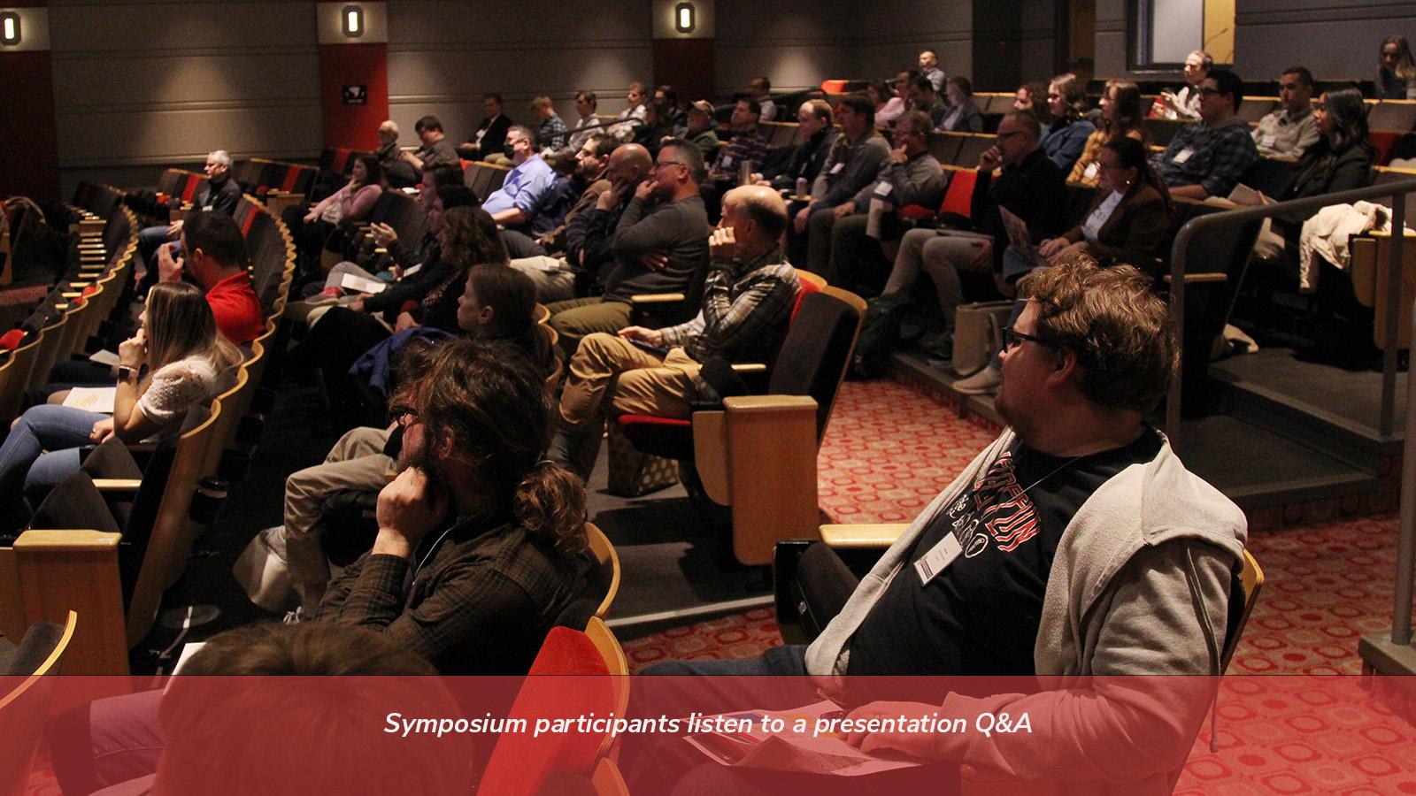 Symposium participants listen to a presentation Q&A