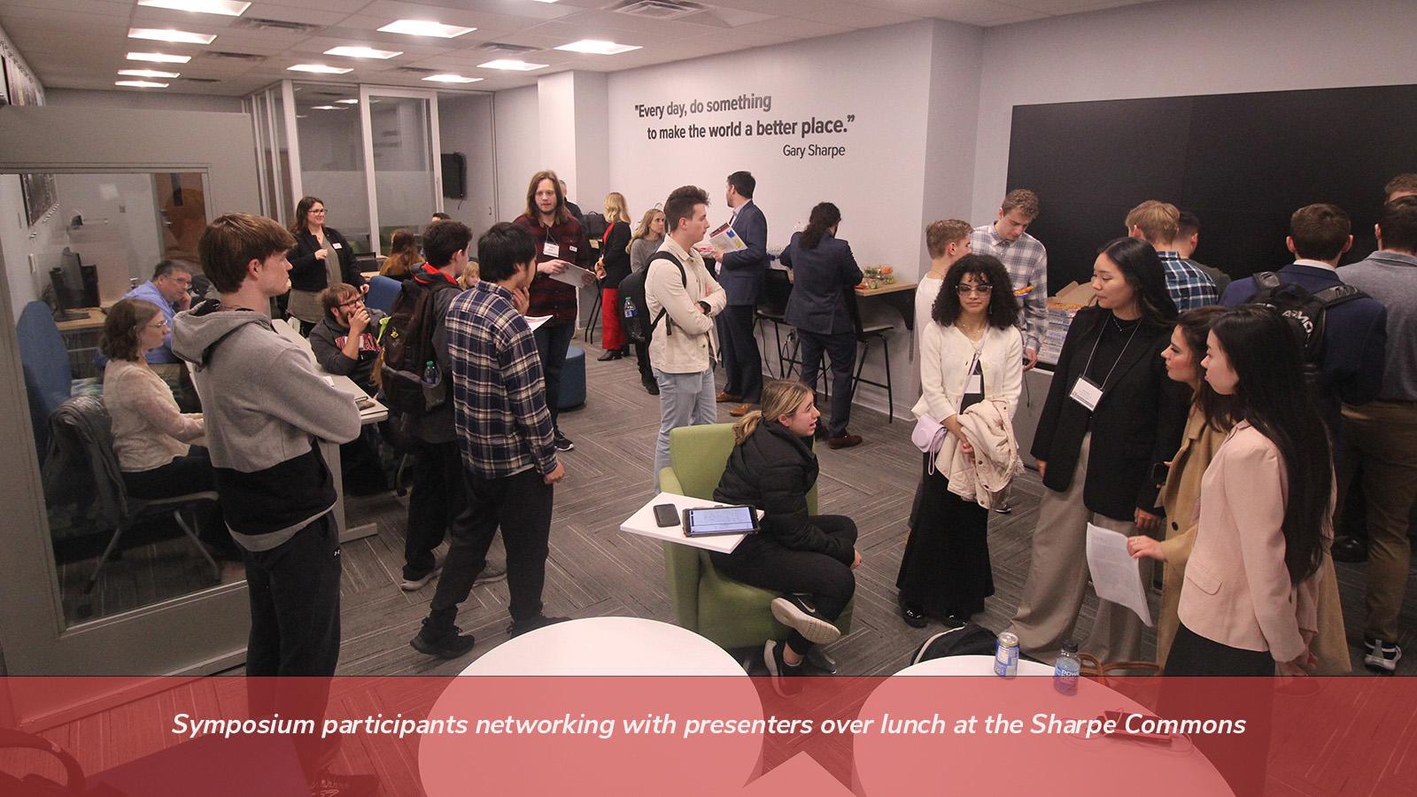 Symosium participants networking with presenters over lunch at the Sharpe Commons