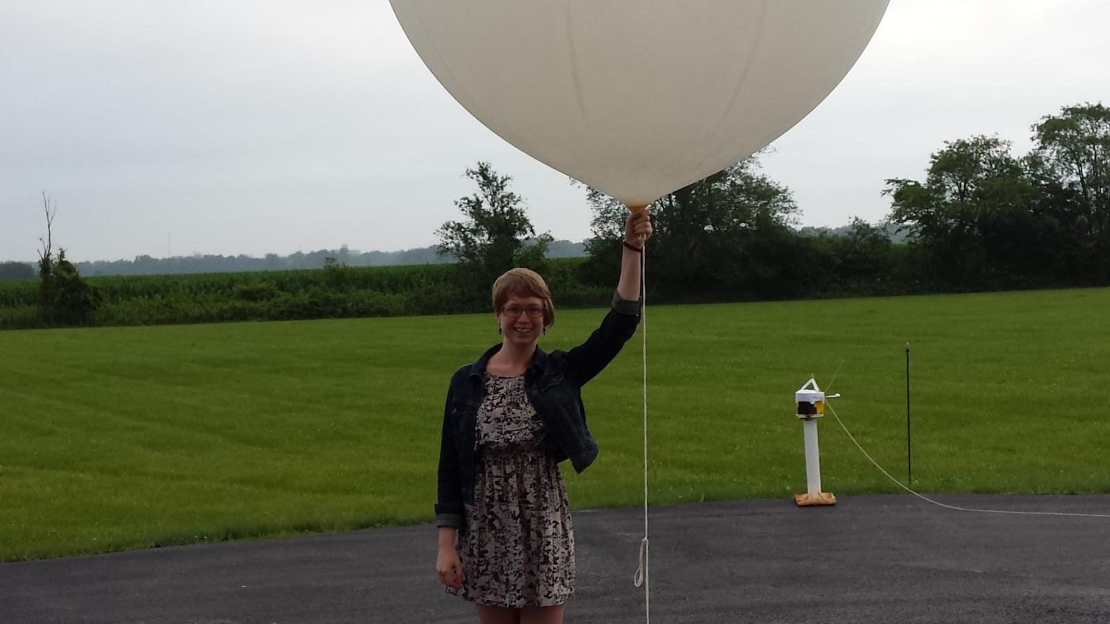 Student launching weather balloon at NWS internship